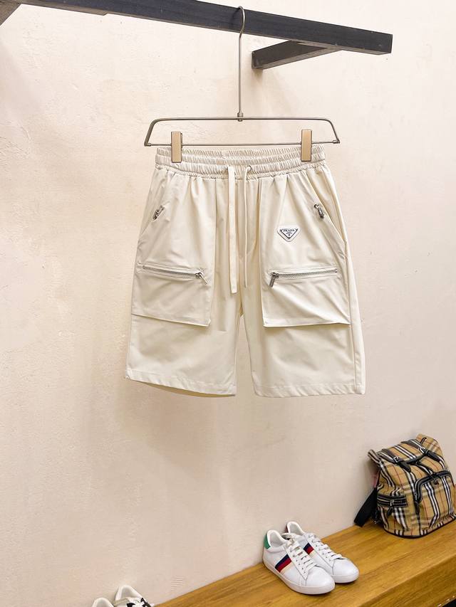 普拉达 2024春夏新款休闲短裤！官网同步发售。定制品牌经典logo，定制面料，舒适度极好，手触感强烈。辨识度极高，完美品相工艺。 尺码：M-3Xl